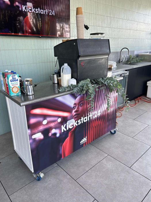 Kickstart 24 event — mobile coffee cart with eucalyptus decoration and ooh! media branding